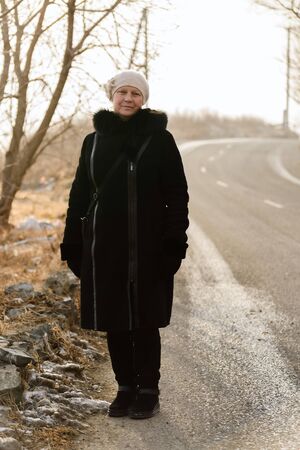 Winter portrait of a beautiful middle-aged woman in a fur coat.の写真素材