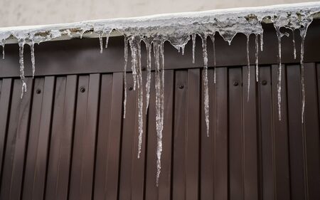 Shiny icicles hang at spring day.の写真素材