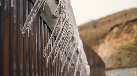 Shiny icicles hang at spring day.の写真素材