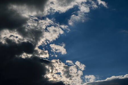 Blue sky with dark clouds. Nature background.の写真素材