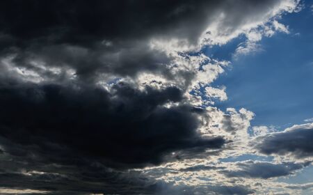 Blue sky with dark clouds. Nature background.の写真素材