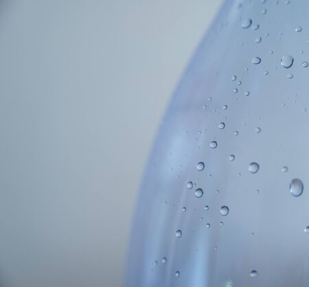 Drops on a glass with selective focus. Color toned image.の写真素材
