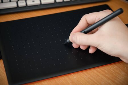 Graphic designer using digital tablet. Selective focus on stylus.の写真素材