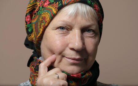 Middle aged woman portrait wearing scarf.の写真素材