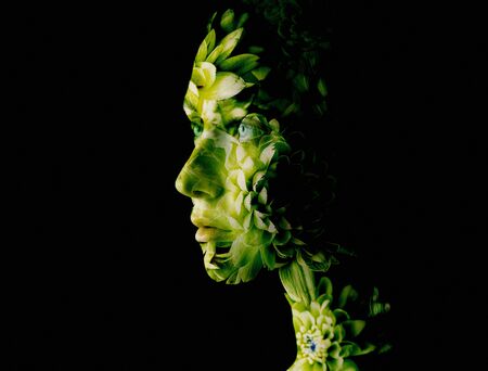 Double exposure of young woman and flowers.の写真素材