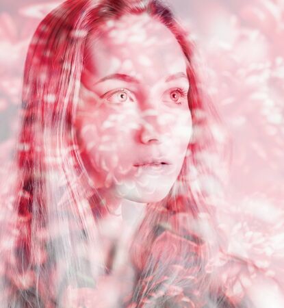 Double exposure of young woman and flowers.の写真素材