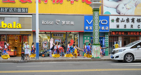 MISHAN, CHINA - JULY 28, 2019: Children dressed in the Chinese traditional costume walk down the street.のeditorial素材