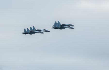 VLADIVOSTOK, RUSSIA - JULY 26, 2020: A group of Russian Knights of four Su-35 in the sky over the city during the celebration of the Day of the Navy.のeditorial素材