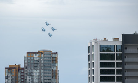 VLADIVOSTOK, RUSSIA - JULY 26, 2020: A group of Russian Knights of four Su-35 in the sky over the city during the celebration of the Day of the Navy.のeditorial素材