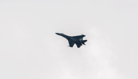 VLADIVOSTOK, RUSSIA - JULY 26, 2020: One Su-35 in the sky over the city during the celebration of the Day of the Navy.のeditorial素材
