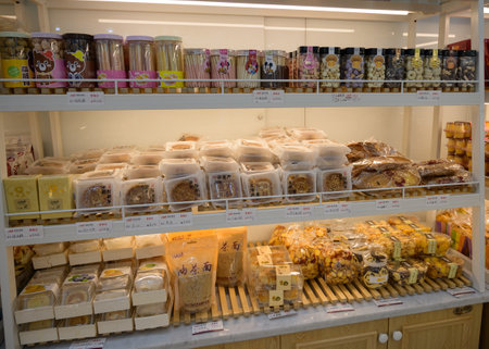 MISHAN, CHINA - JULY 28, 2019: Various baked products at chinese shop. Selective focus.のeditorial素材