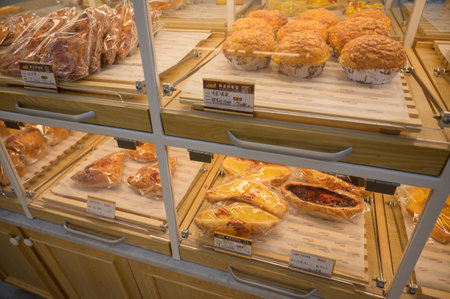 MISHAN, CHINA - JULY 28, 2019: Various baked products at chinese shop. Selective focus.のeditorial素材