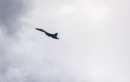 VLADIVOSTOK, RUSSIA - JULY 26, 2020: One Su-35 in the sky over the city during the celebration of the Day of the Navy.のeditorial素材