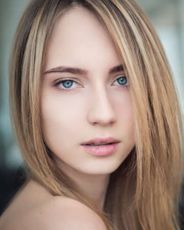 Portrait of a beautiful young woman with blue eyes.の写真素材