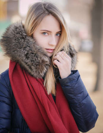 Portrait of young woman at sunny winter day.