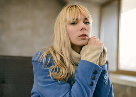 Portrait of young woman wearing blue coat.の写真素材