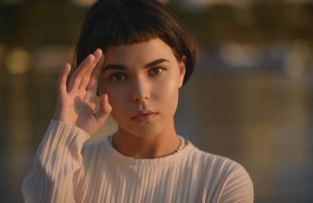 Attractive young woman at sunset.の写真素材