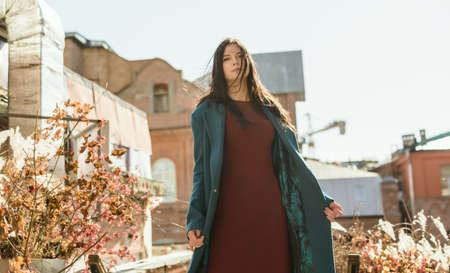 City portrait of beautiful young woman in coat.の写真素材