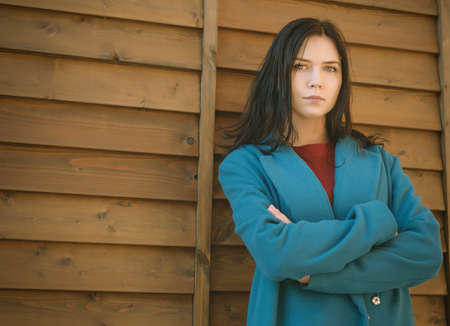City portrait of beautiful young woman in coat.の写真素材