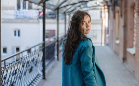 City portrait of beautiful young woman in coat.の写真素材