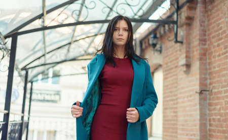 City portrait of beautiful young woman in coat.の写真素材