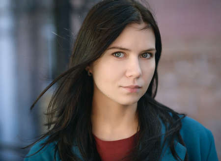 City portrait of beautiful young woman in coat.の写真素材