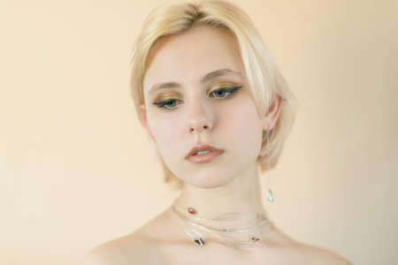 Beautiful young woman with blue eyes. Color toned image.の写真素材