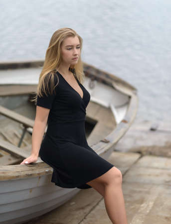 Young woman sitting down on the boat.の写真素材