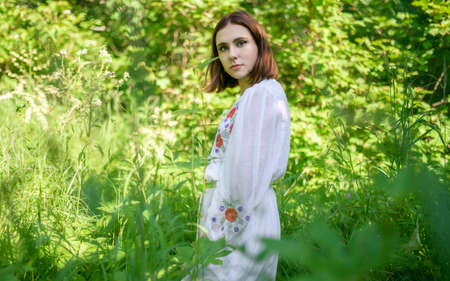 Outdoors portrait of beautiful young woman in the park. Selective focus.