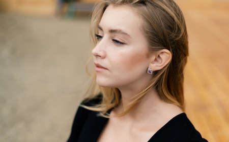 Outdoors portrait of beautiful young woman with blue eyes.の写真素材