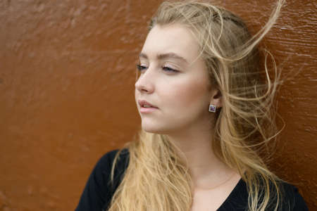 Outdoors portrait of beautiful young woman with blue eyes.の写真素材