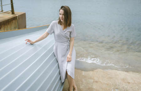 Young woman sitting down on the boat.の写真素材