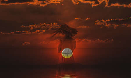Double exposure of young woman and sunset sky.