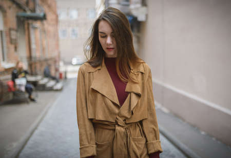 Woman in vintage cloak at street.の写真素材