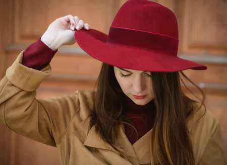 Woman in vintage cloak and red hat.の写真素材