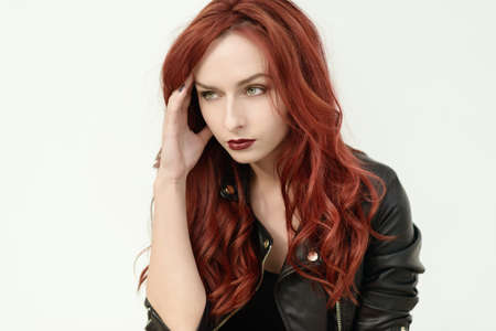 Portrait of attractive red haired young woman with blue eyes.の写真素材