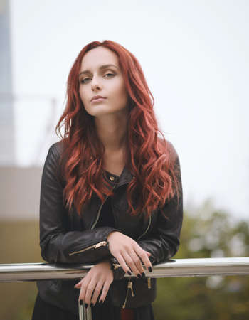 Portrait of attractive red haired young woman with blue eyes.の写真素材