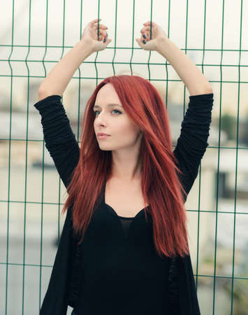 Portrait of attractive red haired young woman with blue eyes.の写真素材