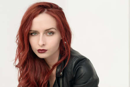 Portrait of attractive red haired young woman with blue eyes.の写真素材