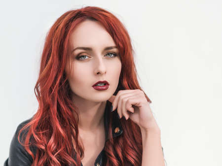 Portrait of attractive red haired young woman with blue eyes.の写真素材