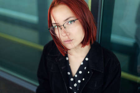 Portrait of beautiful redhead woman wearing glasses.