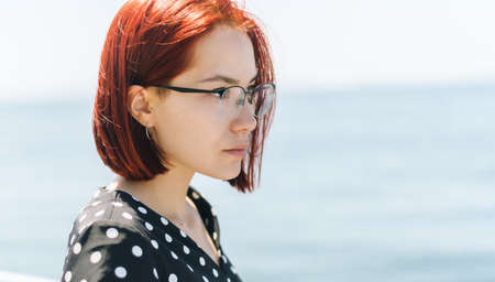 Woman in dress enjoys a walking near the sea shore.の写真素材