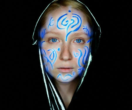 Portrait of young woman with paint on her face.の写真素材