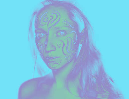 Portrait of young woman with paint on her face.の写真素材