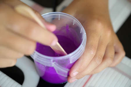 Little girl makes a homemade slime. Selective focus.の写真素材