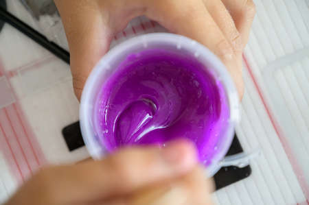 Little girl makes a homemade slime. Selective focus.の写真素材