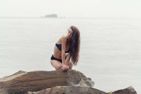 Portrait of young woman on the sea background. Outdoors.の写真素材