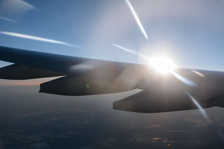 Wing of a airplane at sunrise at an altitude of 11 km.の写真素材