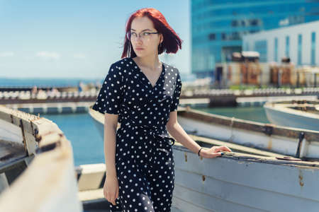 Young woman posing near old boat.の写真素材
