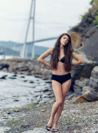 Beautiful brunette woman among the rocks.の写真素材